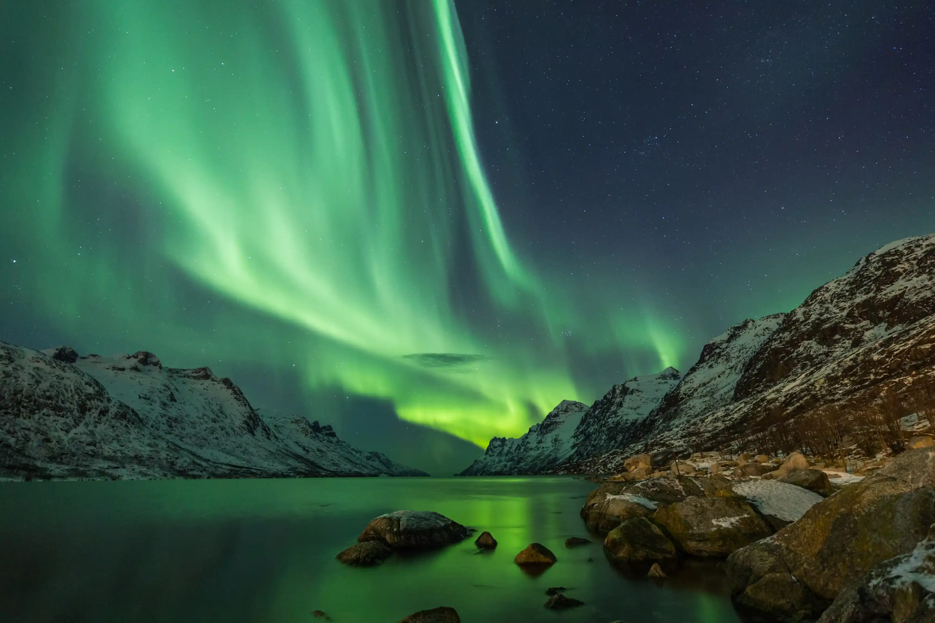 Northern lights over a mountain lake